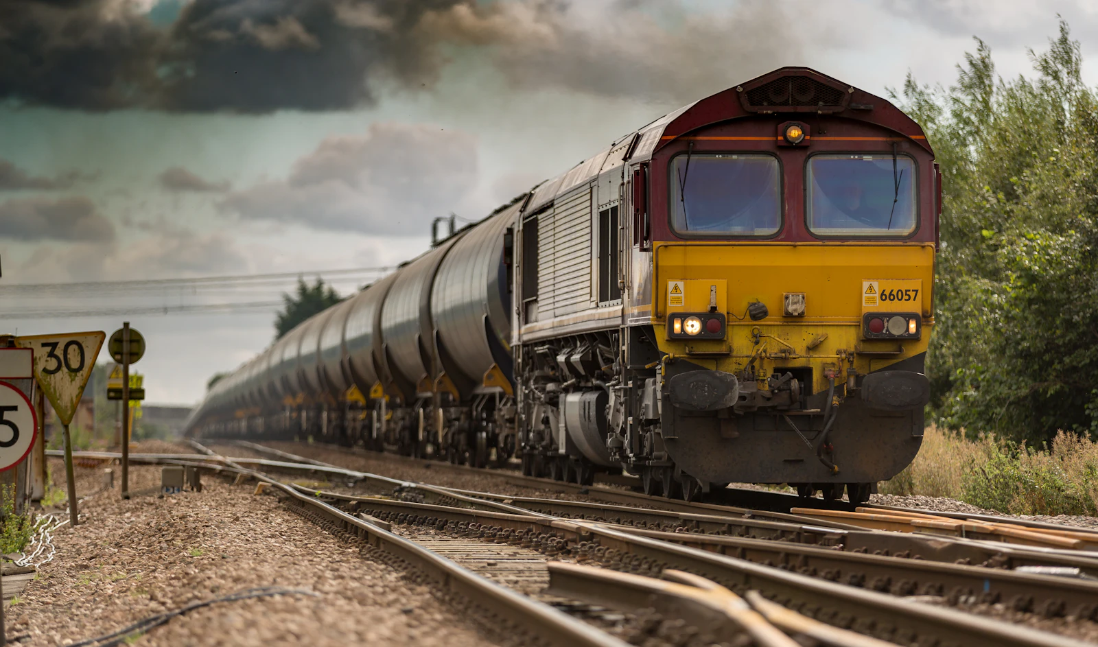 Freight locomotive hauling bulk wagons through a rail junction