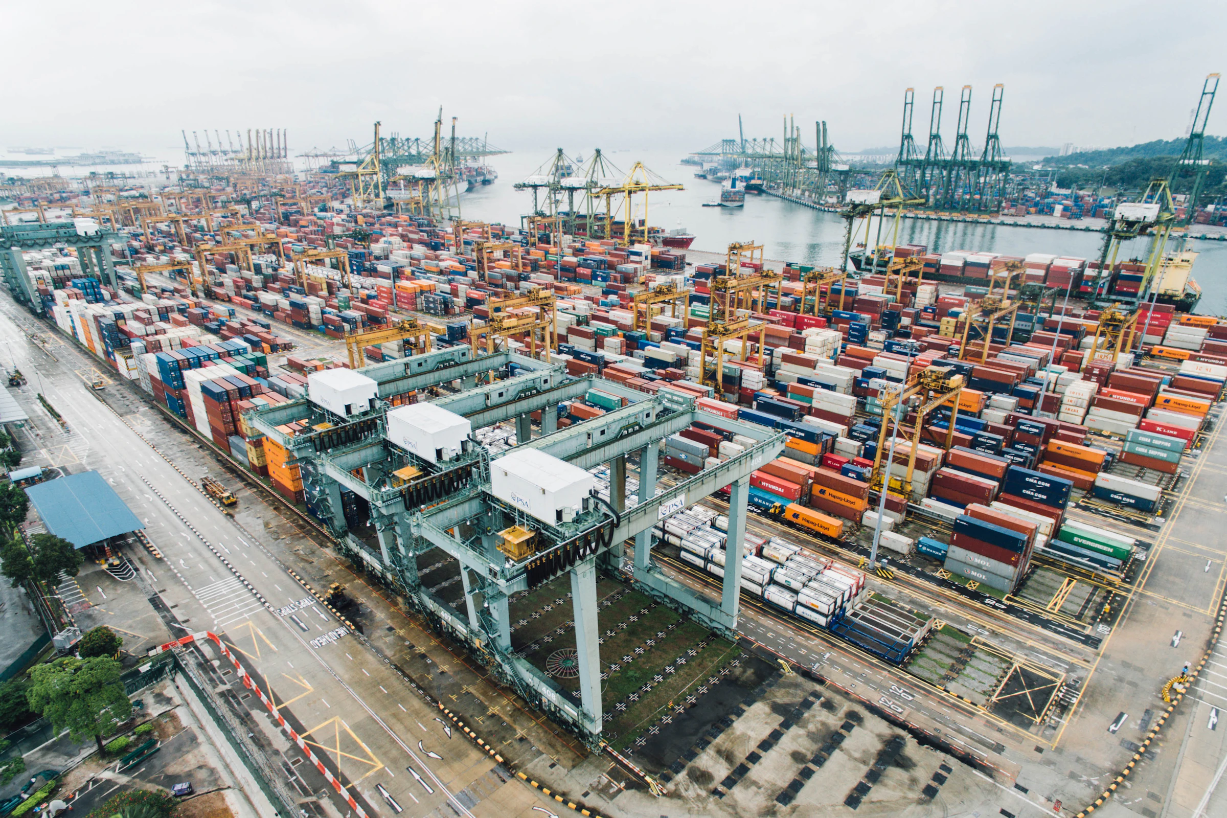 Aerial view of a container terminal with gantry cranes and stacked containers