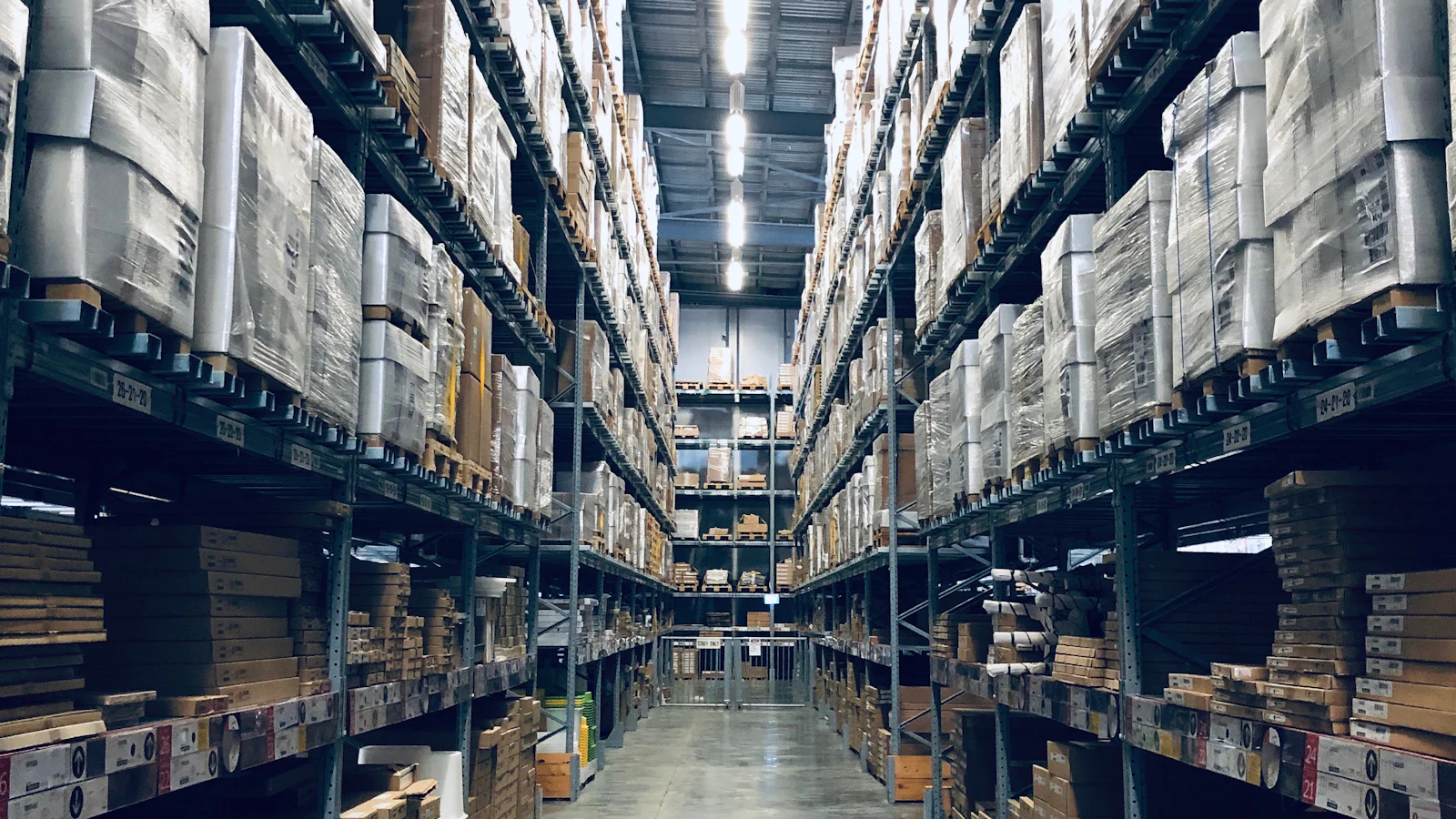 High-bay warehouse aisle with racked palletised stock